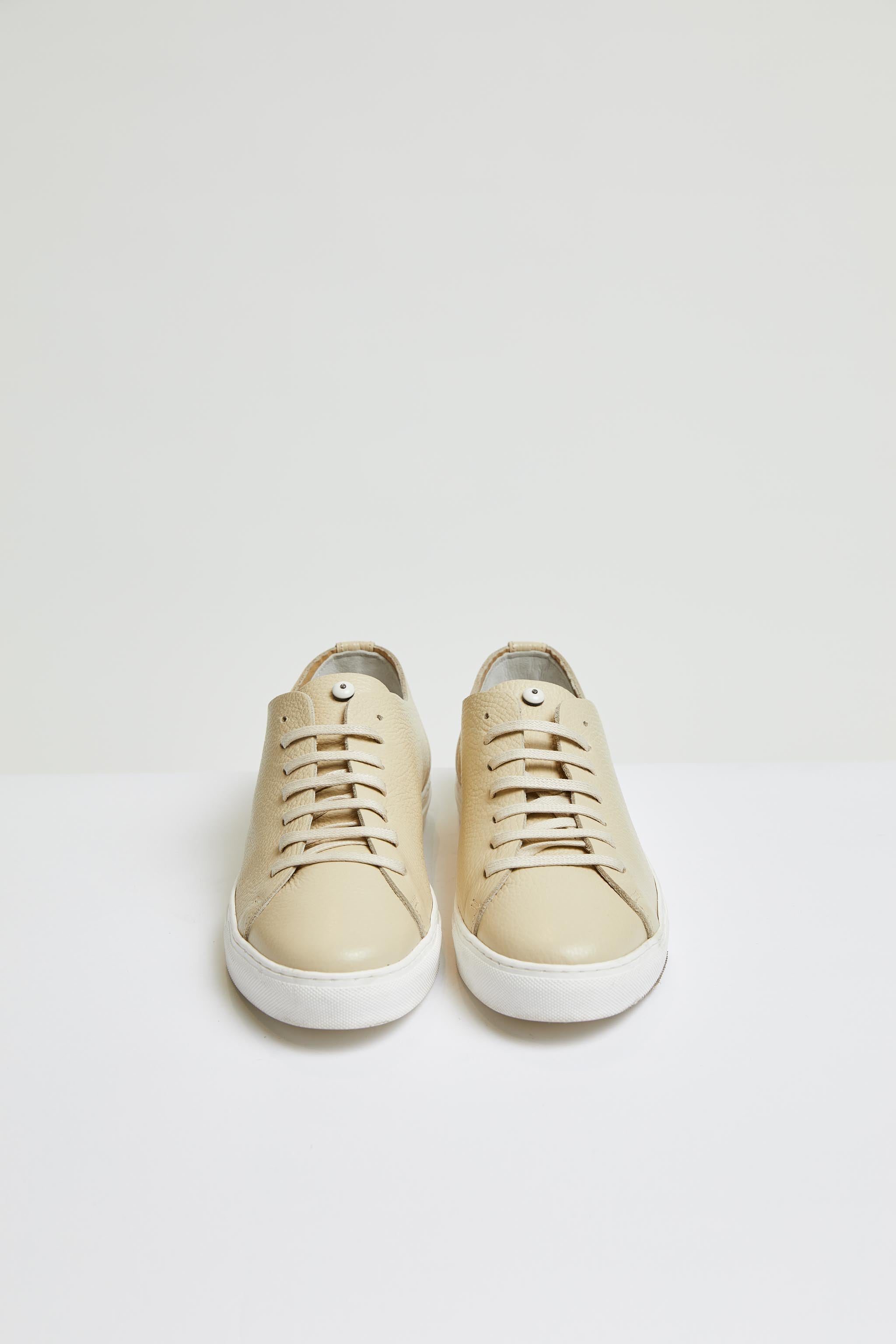 Perforated leather sneaker in beige