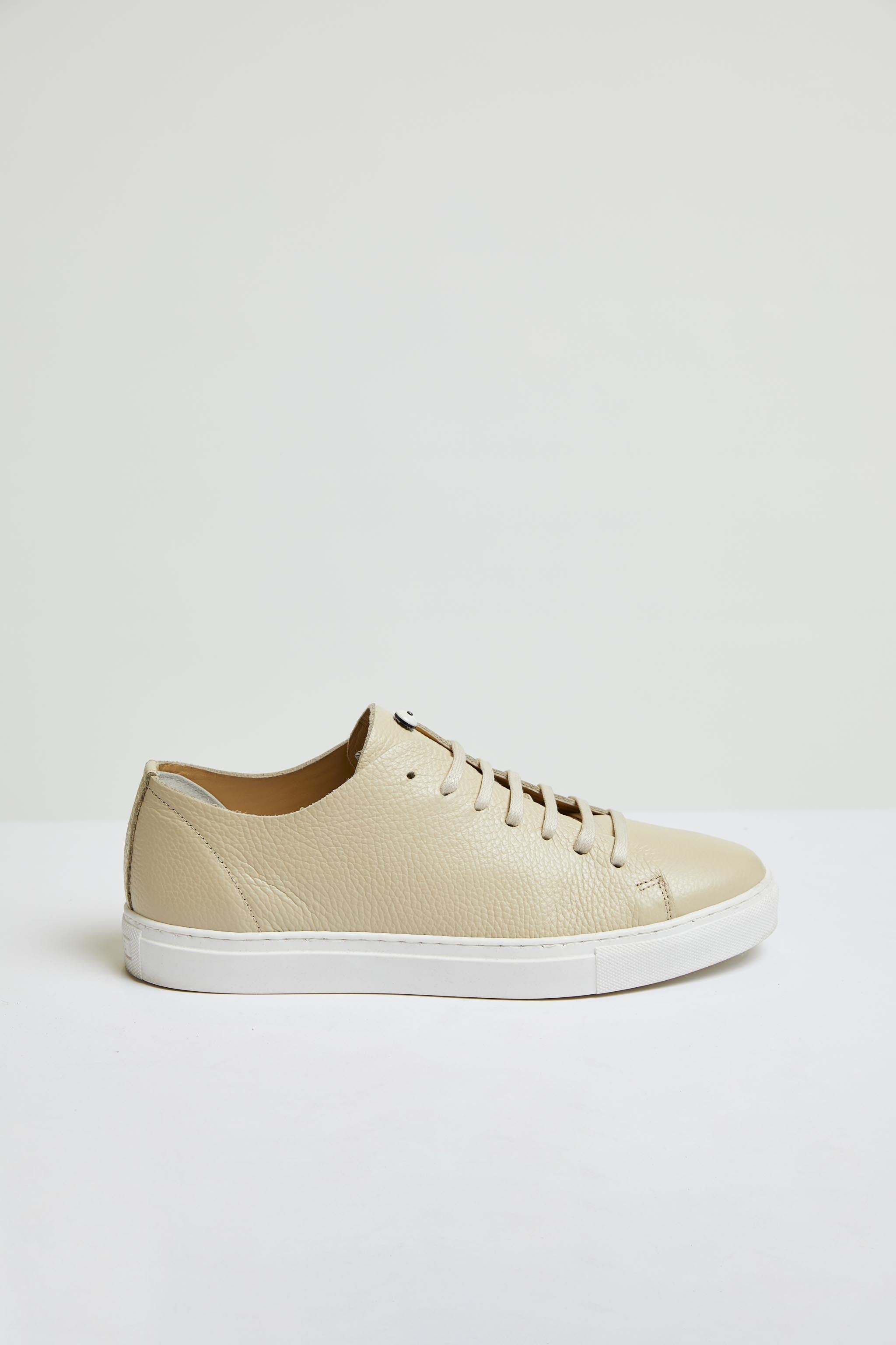 Perforated leather sneaker in beige